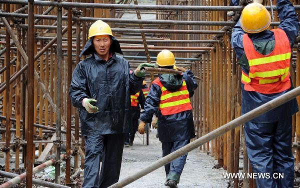 Workers repair the No. 213 National Highway in southwest China's Sichuan Province, commonly known as the 'lifeline' for reconstruction in the mountainous quake zone, after it is blocked after floods in Maoxian County, Sichuan Province, on June 8, 2010.