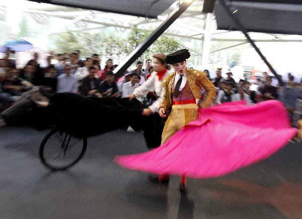 A clown dressed-up as a bullfighter fights with a cart during a performance at the Madrid Case Pavilion of Urban Best Practices Area (UBPA) at the World Expo Park in Shanghai, east China, on June 10, 2010.