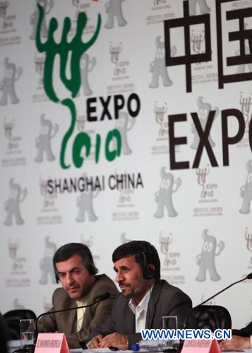 Iranian President Mahmoud Ahmadinejad (R) attends a news conference in Shanghai, east China, June 11, 2010. 
