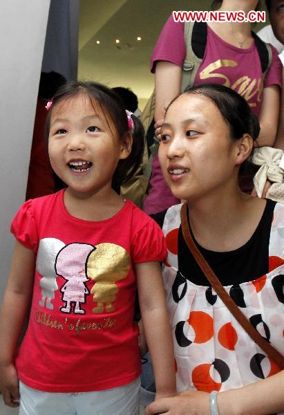 Four-year-old Jiang Yuxiao (R) from Taicang of east China&apos;s Jiangsu Province visits the Germany Pavilion with her mother at the World Expo Park in Shanghai, east China, June 20, 2010. 