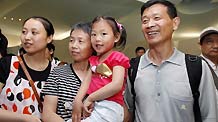 Four-year-old Jiang Yuxiao (R) from Taicang of east China's Jiangsu Province visits the Germany Pavilion with her parents and grandmother at the World Expo Park in Shanghai, east China, June 20, 2010.