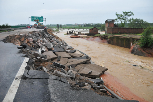 Part of the ruined Jiangxi section of the Shanghai-Kunming Highway is seen on Monday, June 21, 2010. The highway was ruined on Sunday by floods caused by the latest round of torrential rains in southern China. Having sent over 1,000 workers and 200 vehicles to repair the road, local authorities hoped to resume traffic by Monday evening.