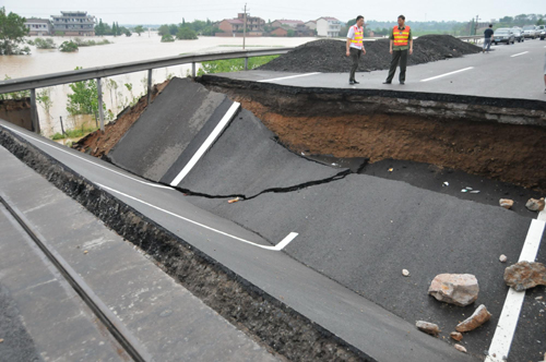 Part of the ruined Jiangxi section of the Shanghai-Kunming Highway is seen on Monday, June 21, 2010. The highway was ruined on Sunday by floods caused by the latest round of torrential rains in southern China. Having sent over 1,000 workers and 200 vehicles to repair the road, local authorities hoped to resume traffic by Monday evening.