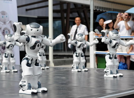 A squad of robots dances at the France Pavilion on June 21, the France National Pavilion Day at Shanghai Expo Park. 