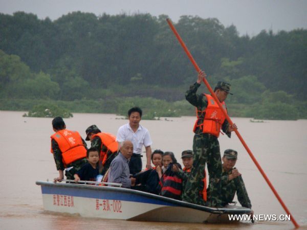 A squad of armed policemen takes the hovercraft in search of the deluge-beleaguered people to transfer them towards the safety belt in a preemptive rescue operation against heavy rainfall, at Jintan Town, Ji'an City, east China's Jiangxi Province, June 20, 2010.