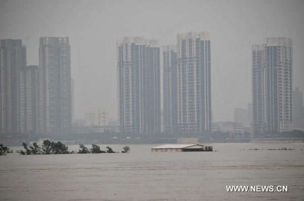 A house on the central shoal of the Ganjiang River is immersed in the flood, in Nanchang City, east China's Jiangxi Province, June 22, 2010.