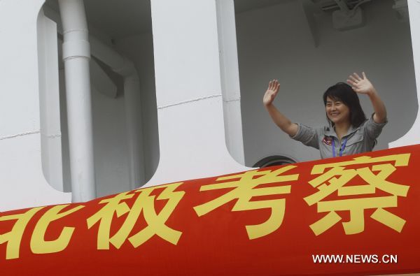 Zhang Jiansong, a reporter with Xinhua, waves to relatives as she participates in China's fourth scientific expedition to the North Pole, on the icebreaker 'Snow Dragon' in the port in Shanghai, east China, June 24, 2010.