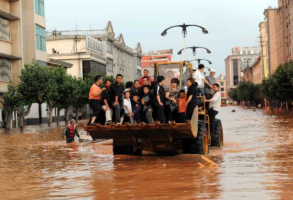 Some local residents are evacuated in Malong County of southwest China's Yunnan Province June 26, 2010. 