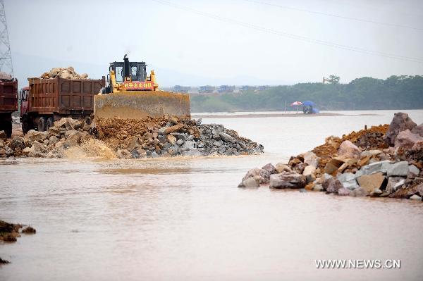 Soldiers work at the breach site of the dike at the Changkai section of the Fuhe River, in Fuzhou City, east China's Jiangxi Province, June 27, 2010. 