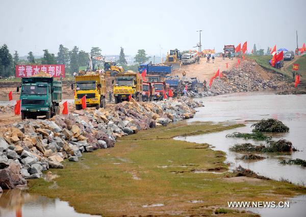 Soldiers work at the breach site of the dike at the Changkai section of the Fuhe River, in Fuzhou City, east China's Jiangxi Province, June 27, 2010. 