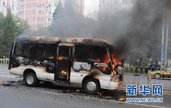 A minivan burns on Xuanwumen West Street, Beijing on June 28, 2010.