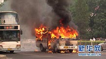 A minivan burns after it self-ignited on Xuanwumen West Street, Beijing on June 28, 2010.