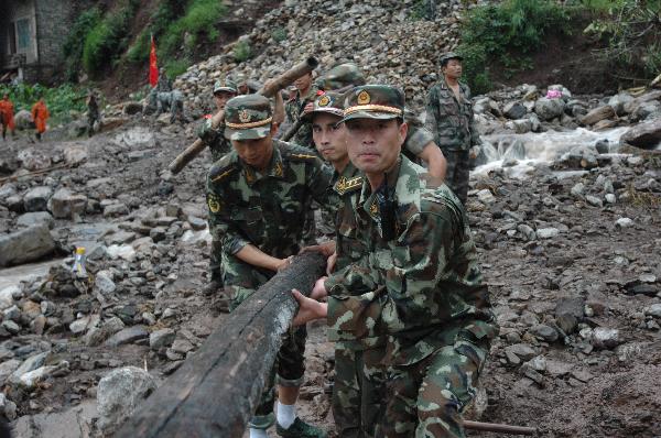 A squadron of armed policemen carry out rescue works, in Dazhai Village, Gangwu Township, of Guanling Bouyei and Miao Autonomous County, southwest China&apos;s Guizhou Province, June 28, 2010. 
