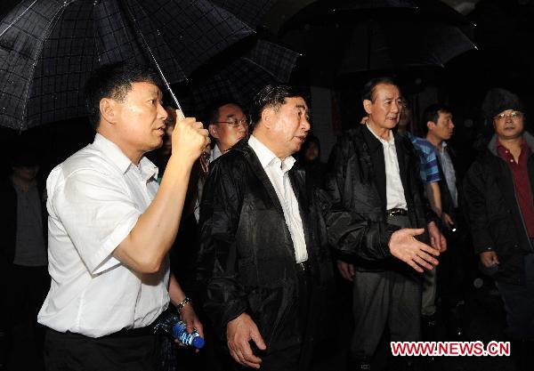 Chinese Vice Premier Hui Liangyu (2nd L Front) instructs the rescue work in Dazhai Village, Gangwu Township of Guanling County, in southwest China's Guizhou Province, June 29, 2010. 