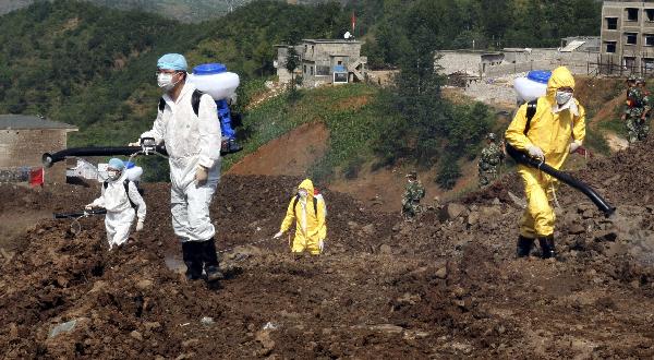 Epidemic prevention workers disinfect the site where a rain-triggered landslide occurred in Guanling County of Anshun City, southwest China's Guizhou Province, July 2, 2010.