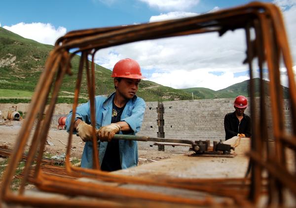 Workers work at a construction site at Changu Village of quake-hit Yushu in northwest China&apos;s Qinghai Province, July 6, 2010.