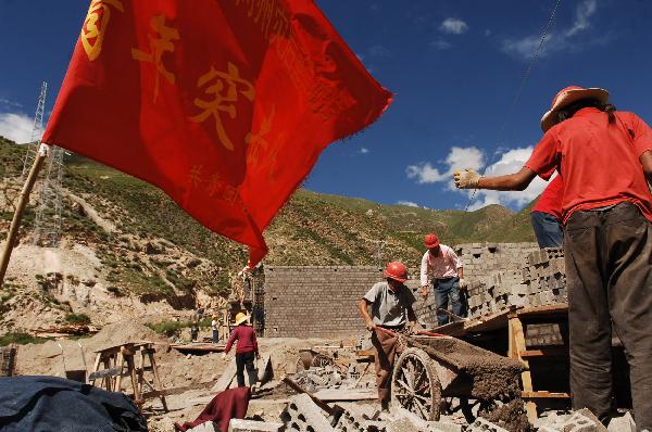Workers work at a construction site at Changu Village of quake-hit Yushu in northwest China&apos;s Qinghai Province, July 6, 2010.