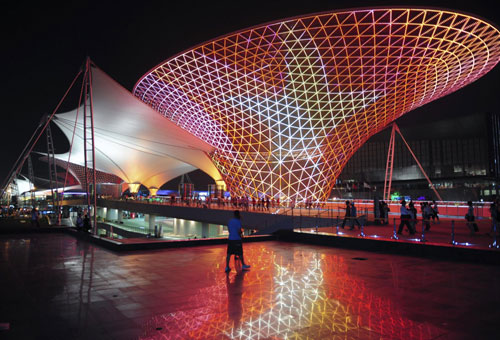 A visitor walks through Expo Square at night, July 10, 2010. 