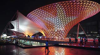 A visitor walks through Expo Square at night, July 10, 2010.