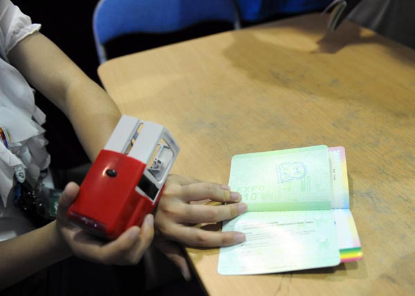 A passport is stamped with the 'octopus lucky seal' in the DEVNET Pavilion of Shanghai Expo, July 12, 2010.