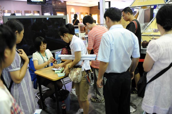 Visitors line up to get the 'octopus lucky seal' stamp in the DEVNET Pavilion of Shanghai Expo, July 12, 2010.