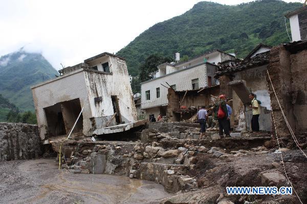 Photo taken on July 13, 2010 shows damaged houses after the ravage of flash floods in Xiaohe Township of Qiaojia County, Zhaotong City, southwest China's Yunnan Province.