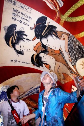 Tomiyo Yamada and her son visit the Japan Pavilion.