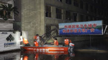 Armed police are searching for people trapped by flood in Guang'an City, southwest China's Sichuan Province, July 19, 2010.