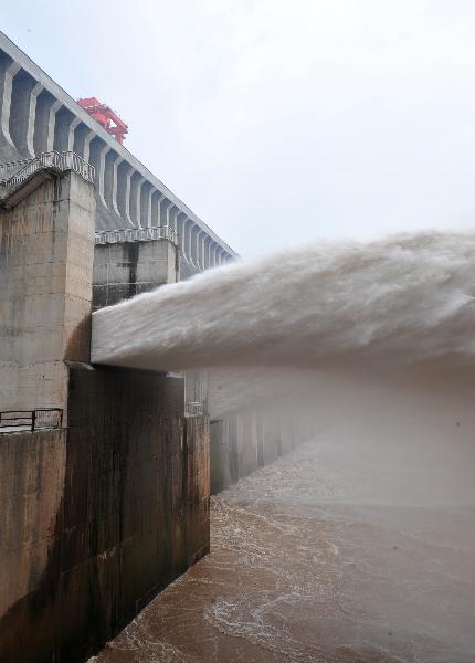 Flood waters are sluiced at the Three Gorges Dam in Yichang, central China's Hubei Province, July 19, 2010.