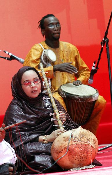 Actors perform folk music during a ceremony to mark the National Pavilion Day for the Islamic Republic of Mauritania at the 2010 World Expo in shanghai, east China, July 19, 2010.