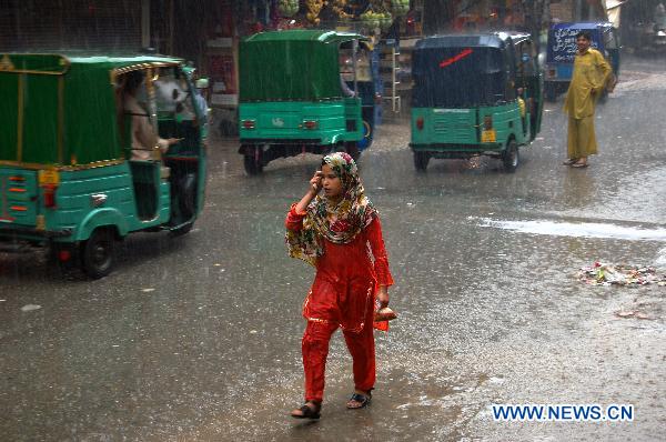 A girl walks through the waterlogged street in northwest Pakistan&apos;s Peshawar on July 22, 2010.