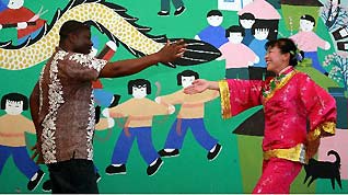 A foreign visitor learns local dance from a villager in Fengjing Township in east China's Shanghai, July 22, 2010.