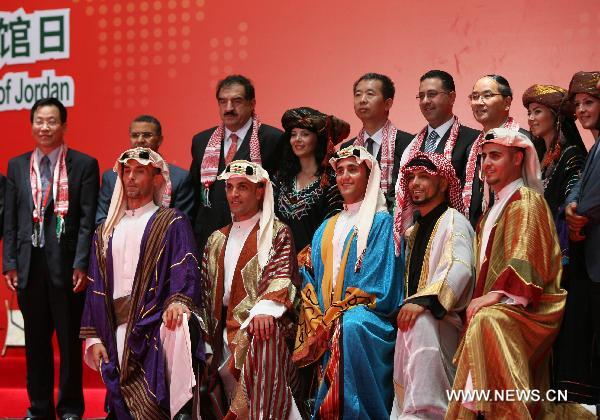 Jordanian and Chinese representatives pose for a group photo with actors during a ceremony to mark the National Pavilion Day for the Hashemite Kingdom of Jordan at the 2010 World Expo in Shanghai, east China, July 25, 2010