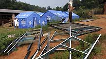 Villagers were evacuated to safety and housed in temporary shelters. Many homes and window frames were broken in Hutang village of Loudi, Central China's Hunan Province, July 28, 2010.