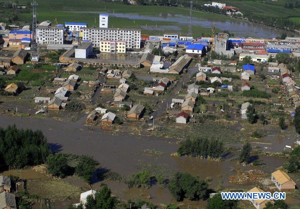 The aerial photo taken on July 29, 2010 shows the flood-stricken towns and villages of Yongji County, northeast China's Jilin Province. Thirteen people were killed and six others missing after floods swept through Yongji County, and disrupted life of 150,000 local residents, officials said Thursday.