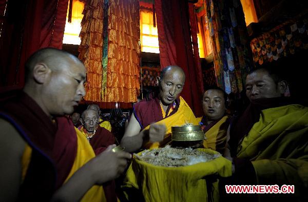 Monk chants sutra to pray for peace and happiness for the sixth Living Buddha Dezhub during the enthronement at Zagor Monastery in Shannan Prefecture of southwest China's Tibet Autonomous Region, Aug. 2, 2010. 