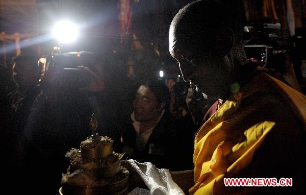 Monk chants sutra to pray for peace and happiness for the sixth Living Buddha Dezhub during the enthronement at Zagor Monastery in Shannan Prefecture of southwest China's Tibet Autonomous Region, Aug. 2, 2010.