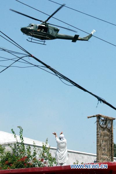 A helicopter flies over the flood-hit areas in northwest Pakistan's Risalpur on August 2, 2010. 