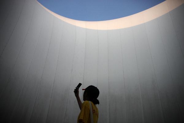 Photo taken on Aug. 1, 2010 shows a tourist taking pictures in the Finland Pavilion at the 2010 World Expo in Shanghai, east China.