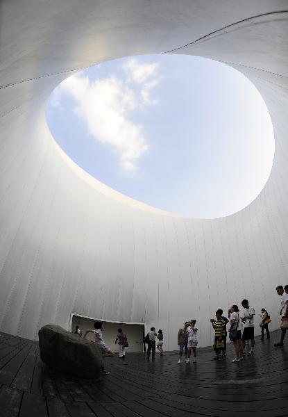 Photo taken on Aug. 1, 2010 shows a mother chasing her son in the Finland Pavilion at the 2010 World Expo in Shanghai, east China. 