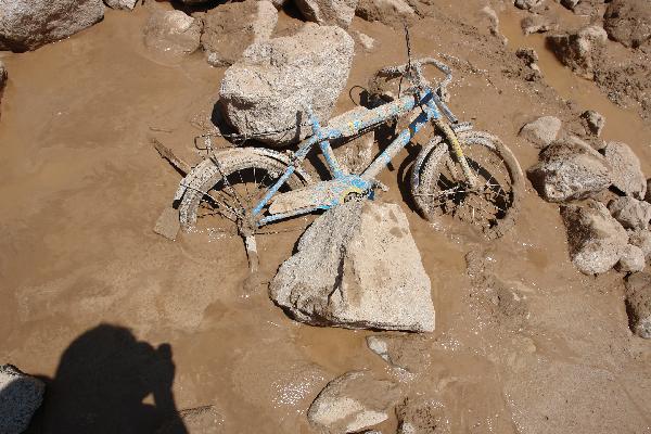 A bike is covered by mud in the affected region at Zhouqu County, Gannan Tibetan Autonomous Prefecture in northwest China's Gansu Province, Aug. 8, 2010. 