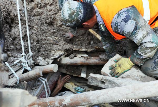 Soldiers rescue a survivor in landslide-hit Zhouqu County, Gannan Tibetan Autonomous Prefecture in northwest China's Gansu Province, Aug. 8, 2010. 