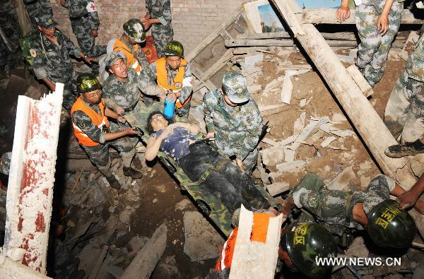 Soliders carry a survivor in landslide-hit Zhouqu County, Gannan Tibetan Autonomous Prefecture in northwest China's Gansu Province, Aug. 8, 2010. 