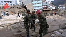 Rescue workers search for survivors in the debris after a landslide in Zhouqu County, Gannan Tibetan Autonomous Prefecture in northwest China's Gansu Province Sunday. More than 680 residents had been rescued by Sunday noon.