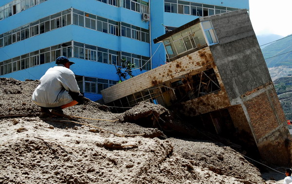 A man looks at his damaged house in mudslide-hit Zhouqu County, northwest China&apos;s Gansu Province, Aug 9, 2010. 