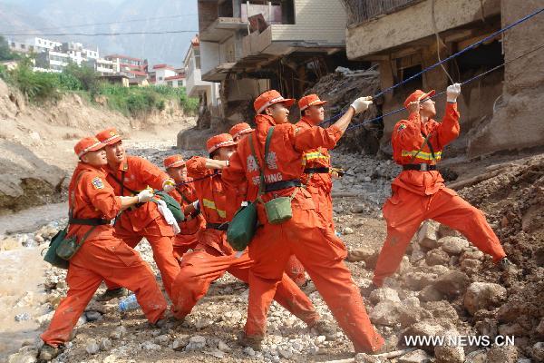 Rescuers demolish damaged houses in the landslide-hit Zhouqu County, Gannan Tibetan Autonomous Prefecture in northwest China's Gansu Province, Aug. 9, 2010. 