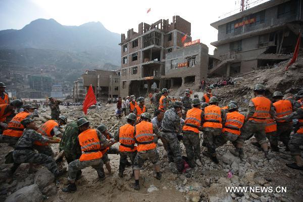 Rescuers work in the landslide-hit Zhouqu County, Gannan Tibetan Autonomous Prefecture in northwest China's Gansu Province, Aug. 9, 2010.