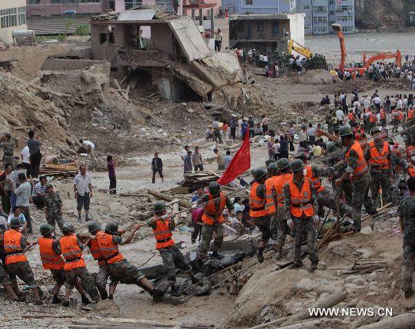 Rescuers work in the landslide-hit Zhouqu County, Gannan Tibetan Autonomous Prefecture in northwest China's Gansu Province, Aug. 9, 2010.