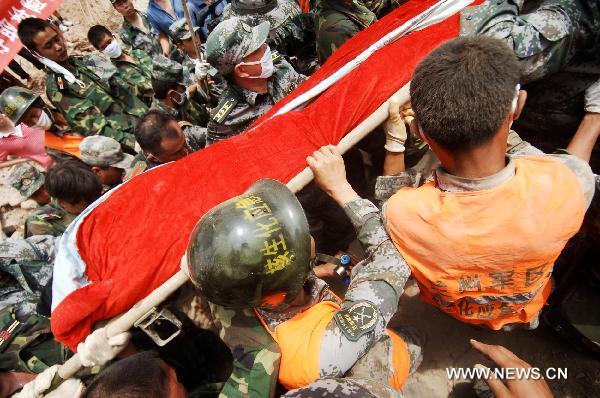 Liuma Shengdai is transported by rescuers in mudslide-hit Zhouqu County, Gannan Tibetan Autonomous Prefecture in northwest China's Gansu Province, Aug. 10, 2010.