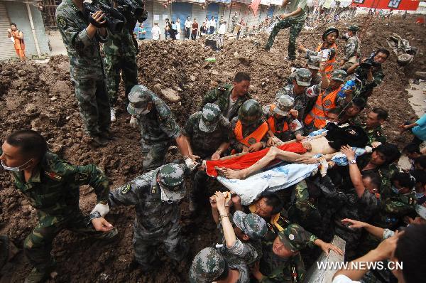 Liuma Shengdai is transported by rescuers in mudslide-hit Zhouqu County, Gannan Tibetan Autonomous Prefecture in northwest China's Gansu Province, Aug. 10, 2010.